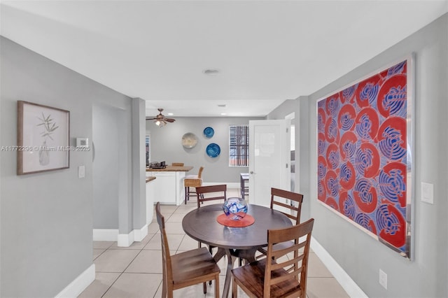 dining space with light tile patterned flooring, a ceiling fan, baseboards, and recessed lighting