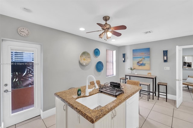 kitchen featuring a ceiling fan, a sink, light tile patterned flooring, dishwasher, and visible vents