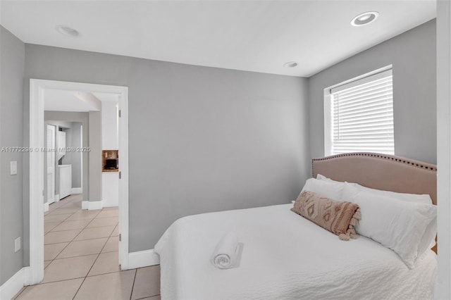 bedroom featuring baseboards and light tile patterned floors