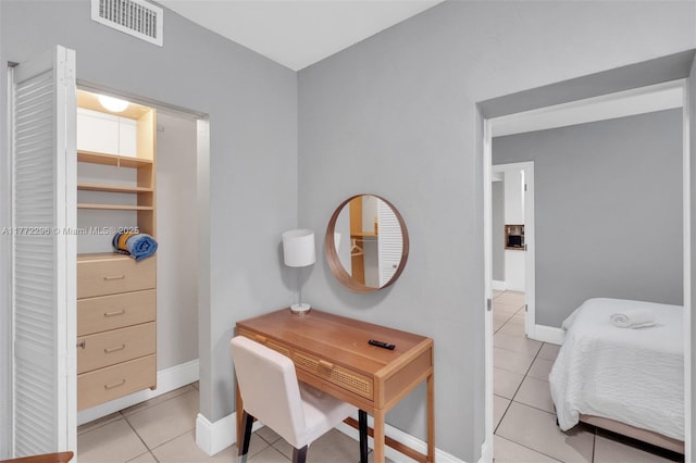 bedroom with baseboards, light tile patterned flooring, and visible vents