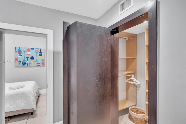 bathroom with baseboards, tile patterned floors, and visible vents