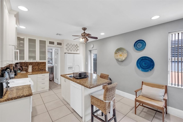 kitchen with ceiling fan, visible vents, white cabinetry, and white appliances