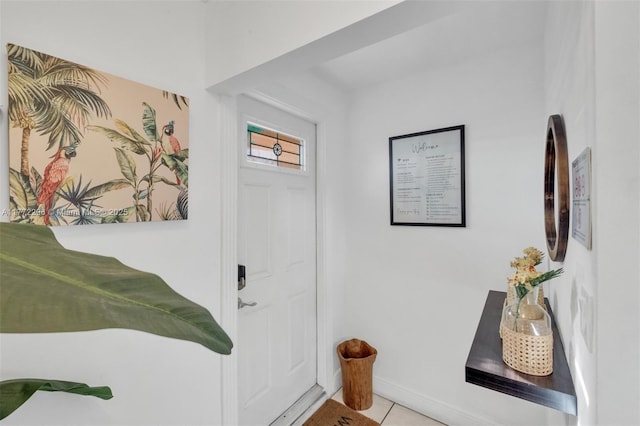 tiled foyer entrance with baseboards
