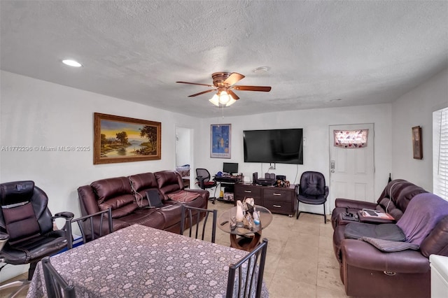 living area featuring recessed lighting, a textured ceiling, and ceiling fan
