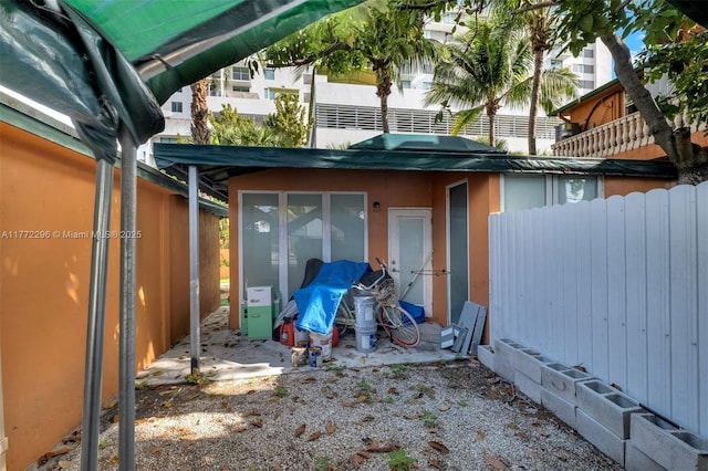exterior space with fence and stucco siding