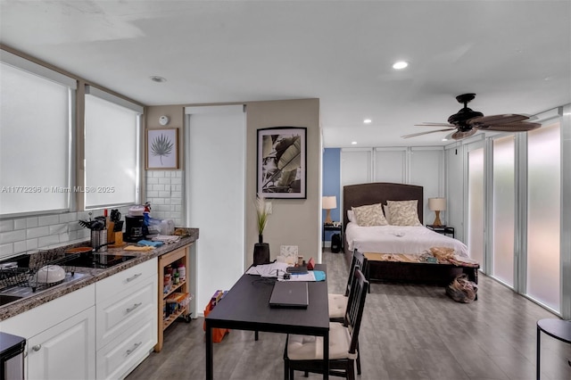 bedroom with a ceiling fan, wood finished floors, and recessed lighting