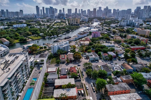 birds eye view of property featuring a city view and a water view