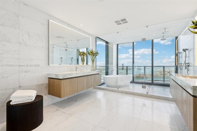 bathroom with vanity, visible vents, floor to ceiling windows, and a stall shower