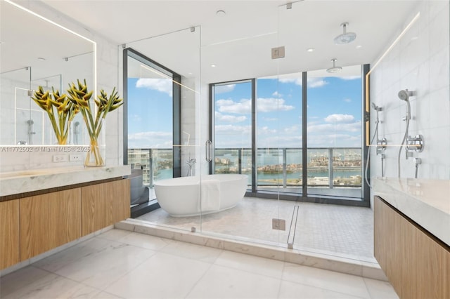 full bathroom featuring a shower, floor to ceiling windows, vanity, and a freestanding bath