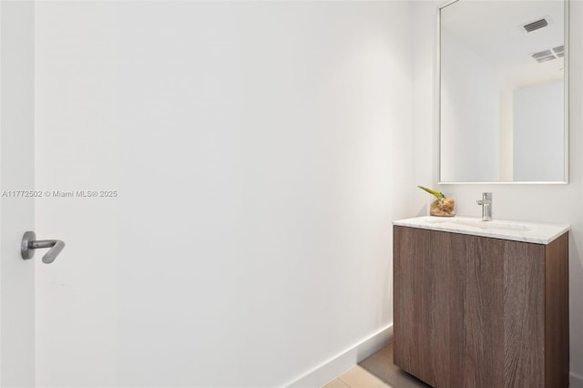bathroom featuring baseboards, vanity, and visible vents