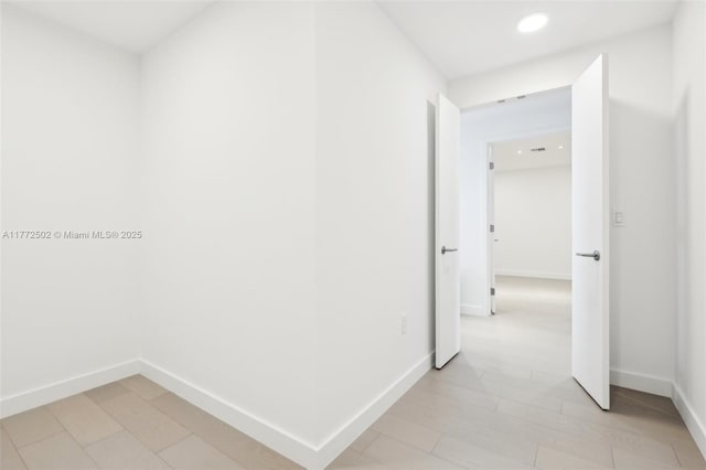 hallway with baseboards and recessed lighting