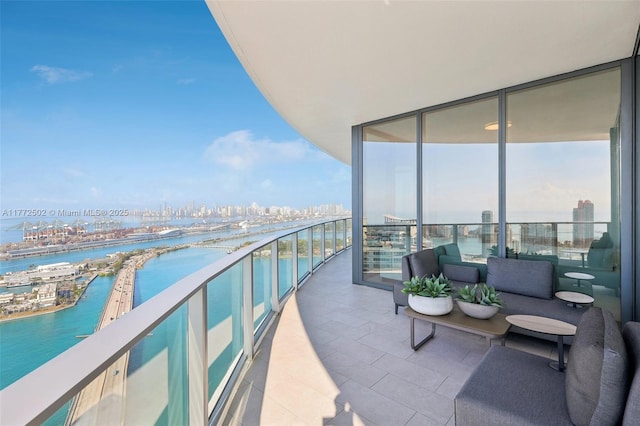 balcony featuring a city view and a water view