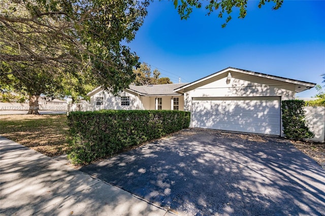 ranch-style home featuring driveway and a garage
