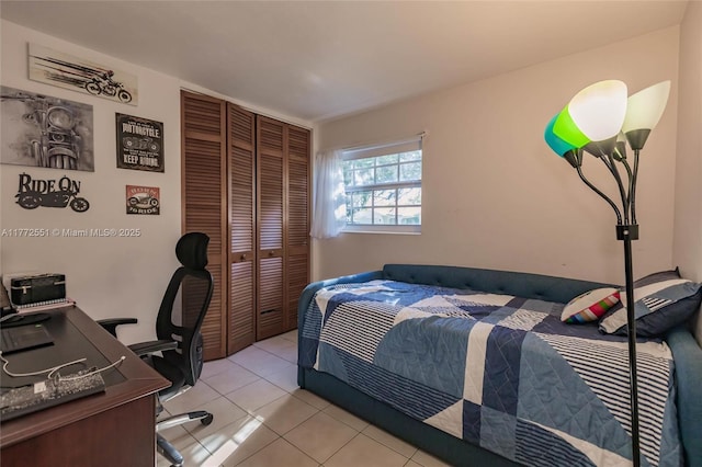 bedroom featuring a closet and light tile patterned floors