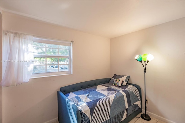 bedroom with tile patterned floors and baseboards