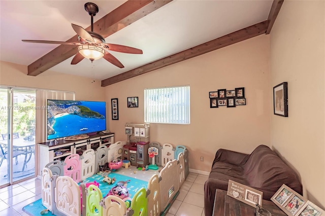living area featuring a ceiling fan, tile patterned floors, lofted ceiling with beams, and baseboards