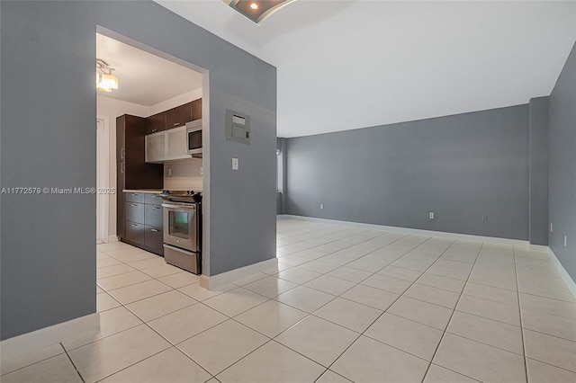 1030 9th St Unit 203, Miami Beach, FL 33139 - kitchen featuring stainless steel appliances, light tile patterned floors, open floor plan, and dark brown cabinetry