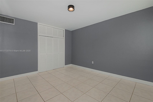 1030 9th St Unit 203, Miami Beach, FL 33139 - unfurnished bedroom featuring a closet and light tile patterned flooring