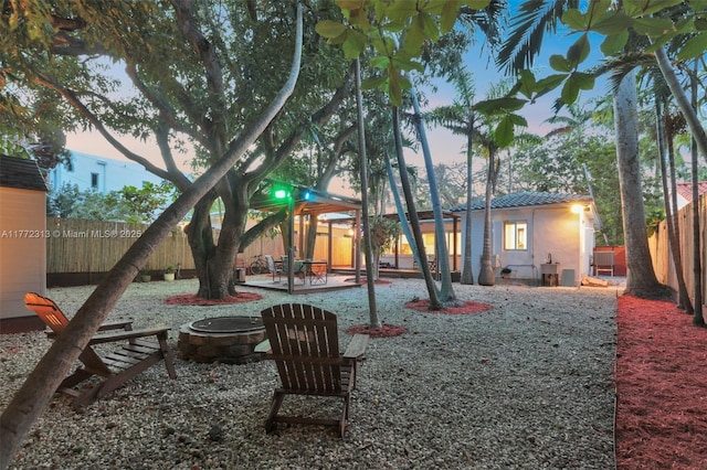 view of jungle gym with a patio area, an outdoor fire pit, and a fenced backyard