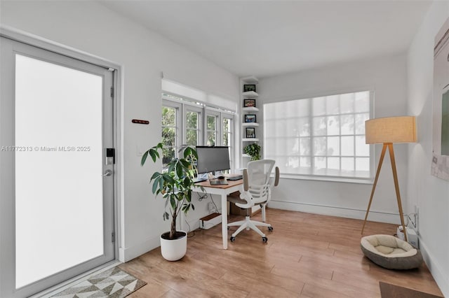 office area featuring baseboards and wood finished floors