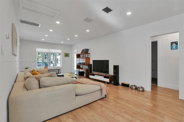 living room featuring baseboards, recessed lighting, attic access, visible vents, and wood finished floors