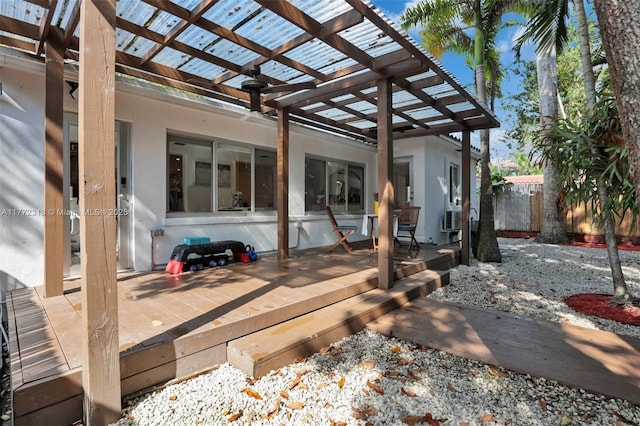 view of patio with a deck, a pergola, and fence