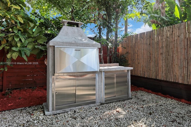 view of greenhouse featuring fence