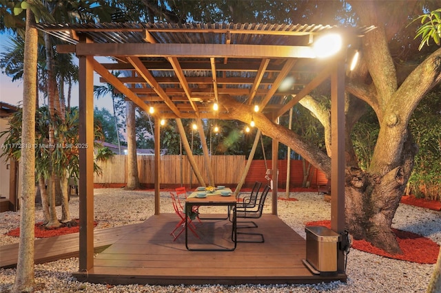 view of patio / terrace featuring a fenced backyard, a wooden deck, and outdoor dining area