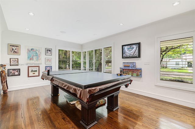 game room featuring baseboards, a wealth of natural light, and dark wood finished floors