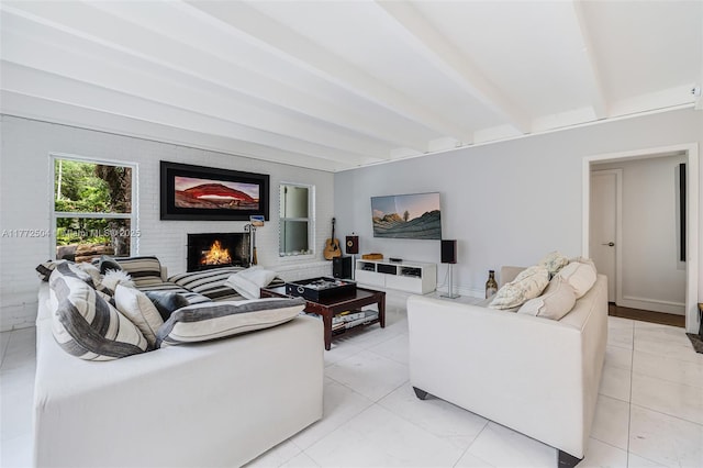 living area featuring beam ceiling and a fireplace