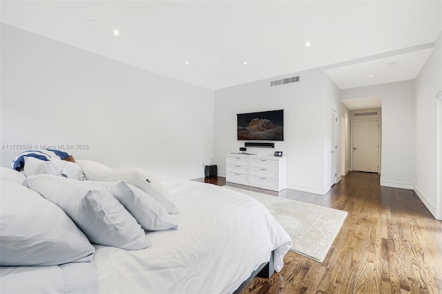 bedroom featuring baseboards, visible vents, recessed lighting, and wood finished floors