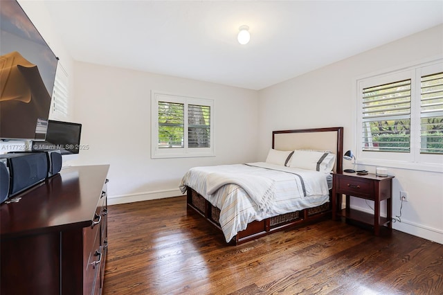 bedroom featuring baseboards and wood finished floors