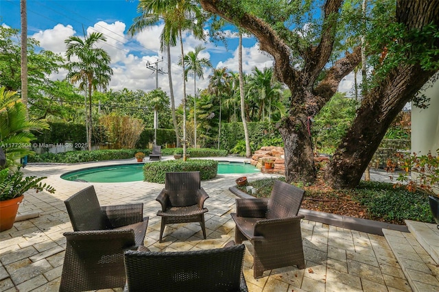 outdoor pool with a patio area