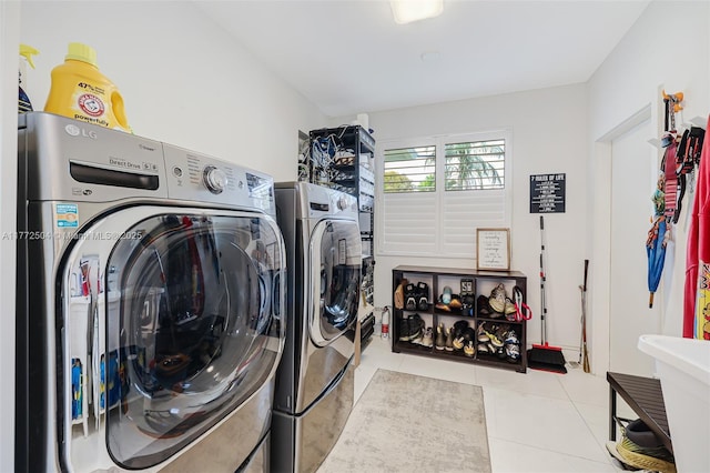 laundry room with washing machine and dryer, laundry area, and tile patterned flooring