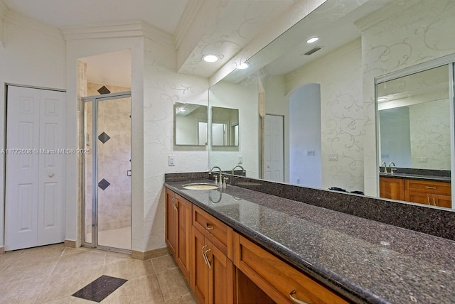 bathroom featuring crown molding, vanity, visible vents, and a shower stall
