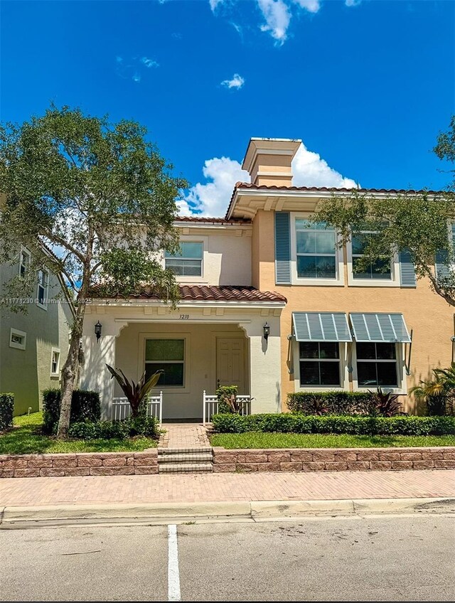 3210 NW 126th Ave Unit 3210, Sunrise, FL 33323 - view of front facade featuring a tiled roof, stucco siding, and covered porch