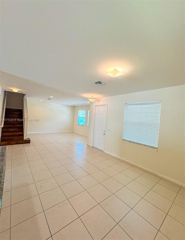 3210 NW 126th Ave Unit 3210, Sunrise, FL 33323 - unfurnished room with light tile patterned floors, stairway, and baseboards