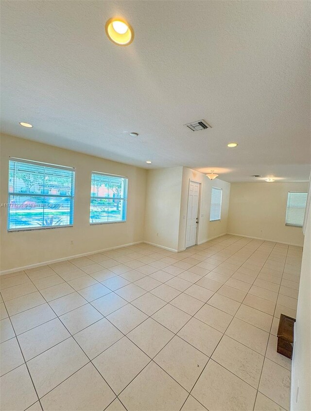 3210 NW 126th Ave Unit 3210, Sunrise, FL 33323 - unfurnished room with plenty of natural light, recessed lighting, light tile patterned flooring, a textured ceiling, and baseboards