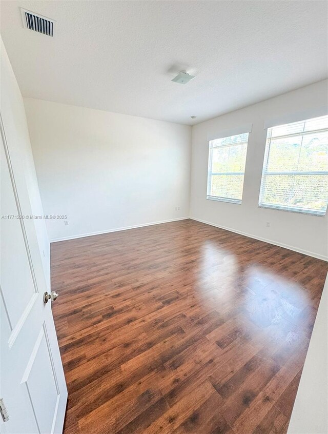 3210 NW 126th Ave Unit 3210, Sunrise, FL 33323 - spare room with dark wood-type flooring and baseboards