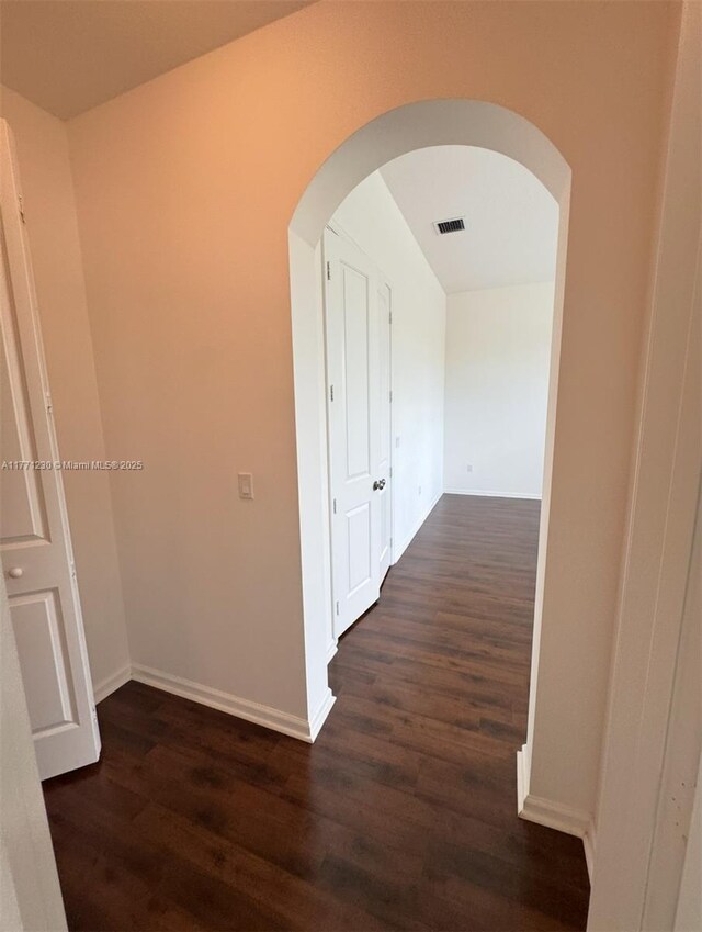 3210 NW 126th Ave Unit 3210, Sunrise, FL 33323 - hall with arched walkways, dark wood-type flooring, and baseboards