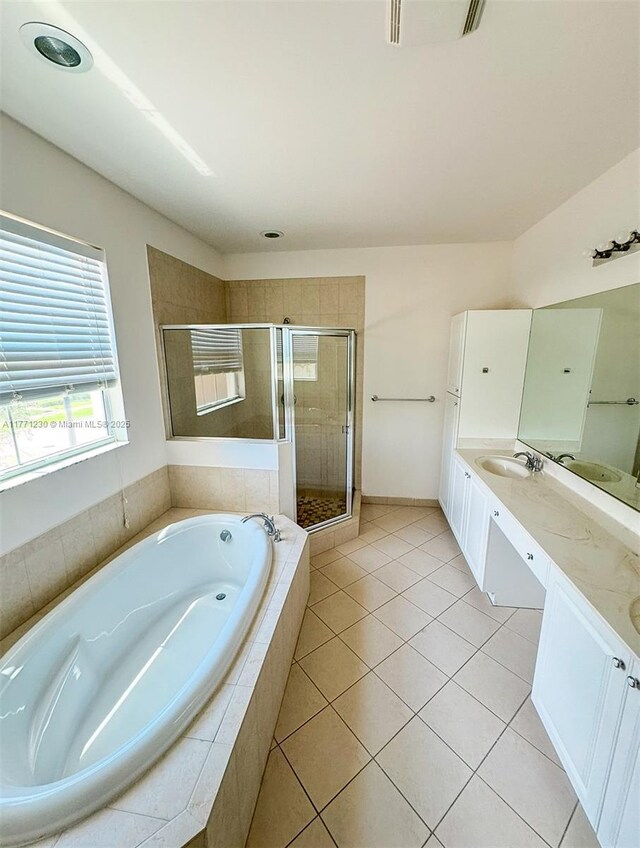 3210 NW 126th Ave Unit 3210, Sunrise, FL 33323 - full bathroom featuring double vanity, a garden tub, a shower stall, and tile patterned floors