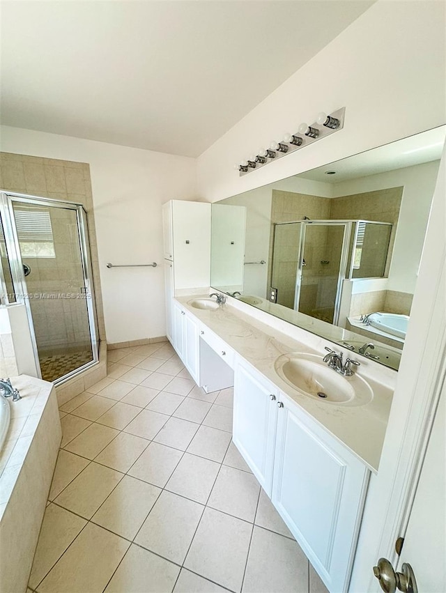 3210 NW 126th Ave Unit 3210, Sunrise, FL 33323 - full bathroom featuring a stall shower, tile patterned flooring, a bath, double vanity, and baseboards
