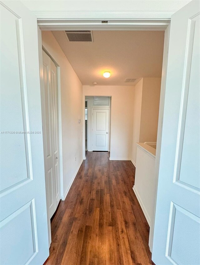 3210 NW 126th Ave Unit 3210, Sunrise, FL 33323 - corridor featuring dark wood-style floors and baseboards