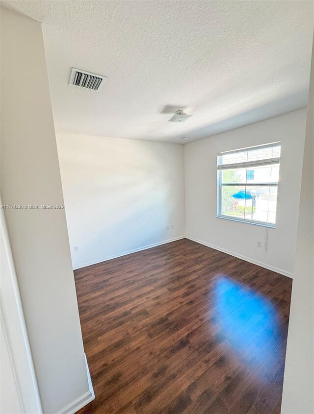 3210 NW 126th Ave Unit 3210, Sunrise, FL 33323 - unfurnished room with a textured ceiling, wood finished floors, and baseboards