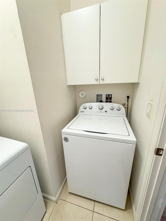 3210 NW 126th Ave Unit 3210, Sunrise, FL 33323 - laundry room with washer / clothes dryer, cabinet space, light tile patterned flooring, and baseboards