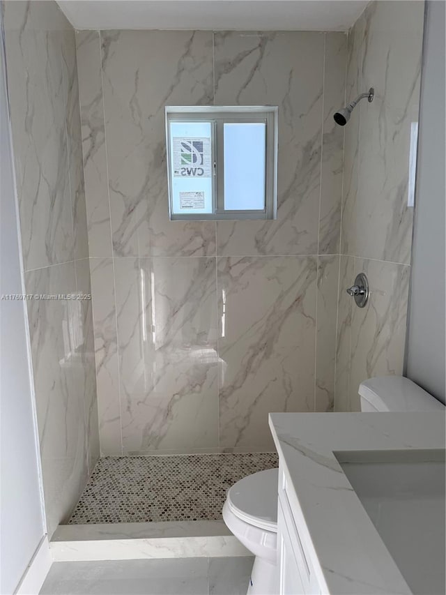 bathroom with a marble finish shower, toilet, and vanity