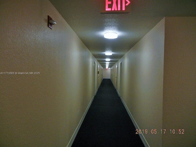 hall featuring baseboards