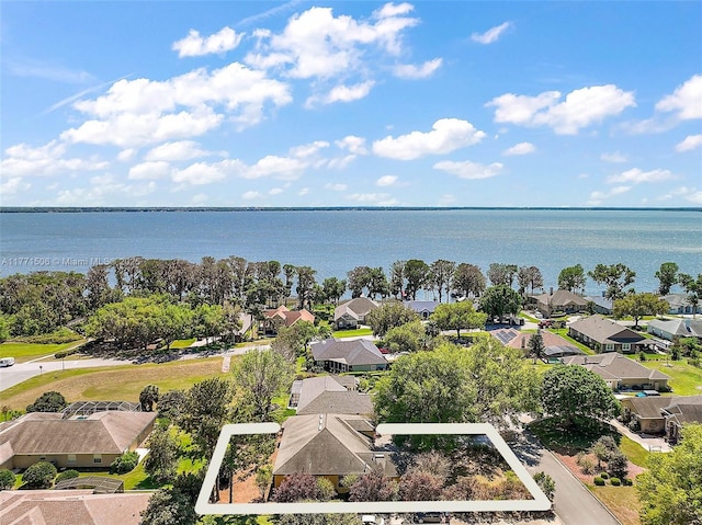 drone / aerial view featuring a residential view and a water view