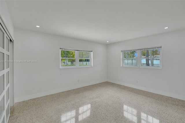 2125 Alamanda Dr, North Miami, FL 33181 - empty room featuring healthy amount of natural light, speckle patterned floor, baseboards, and recessed lighting