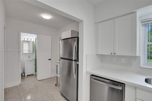 kitchen with light countertops, white cabinets, and stainless steel appliances